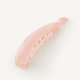 Pink banana hair clip on a white background
