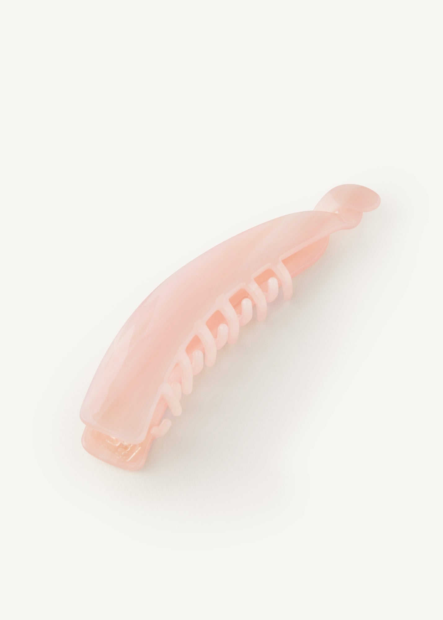Pink banana hair clip on a white background