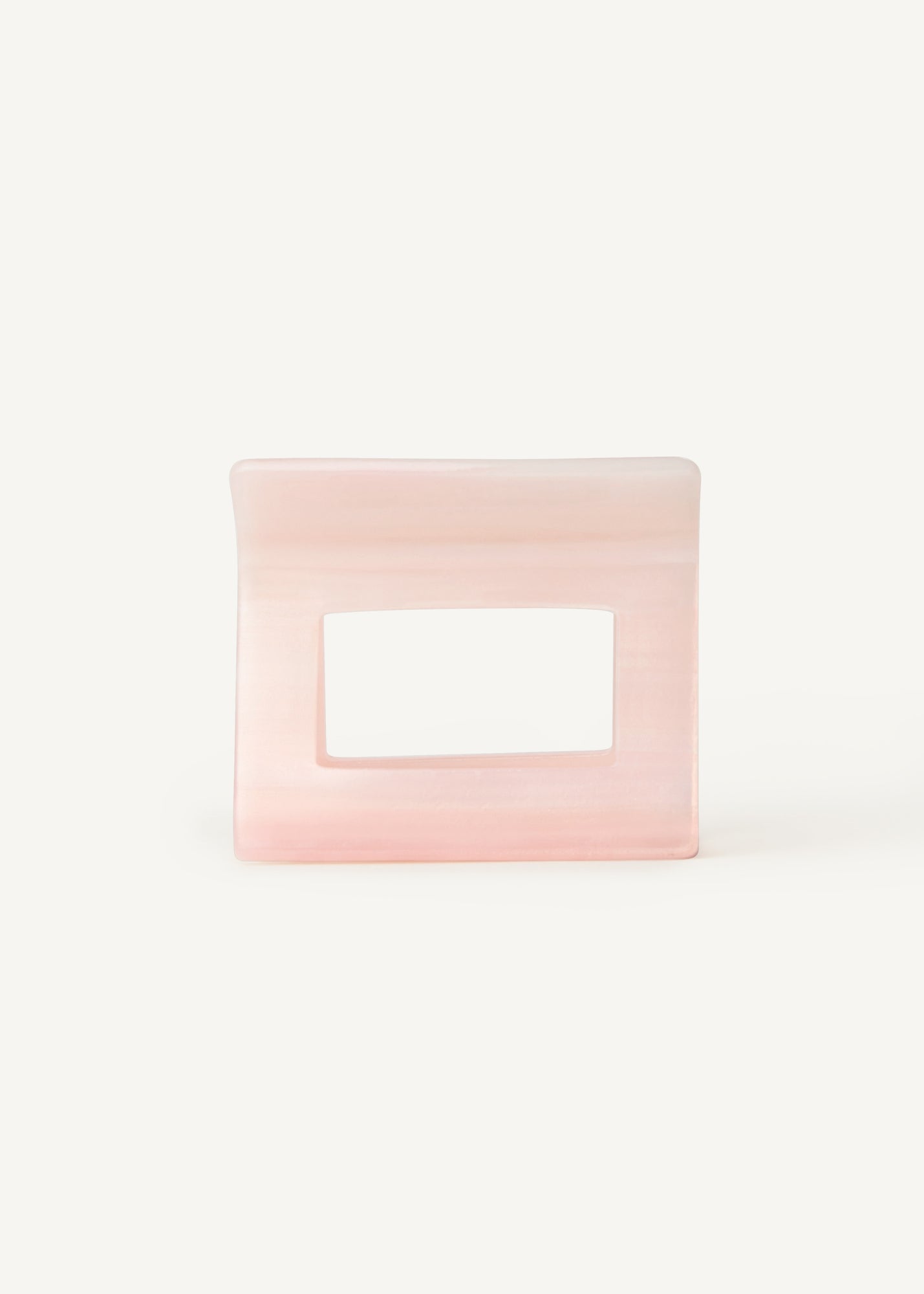 Rectangular pink hair clip against a white background