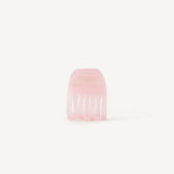 A small transparent pink hair clip on a white background