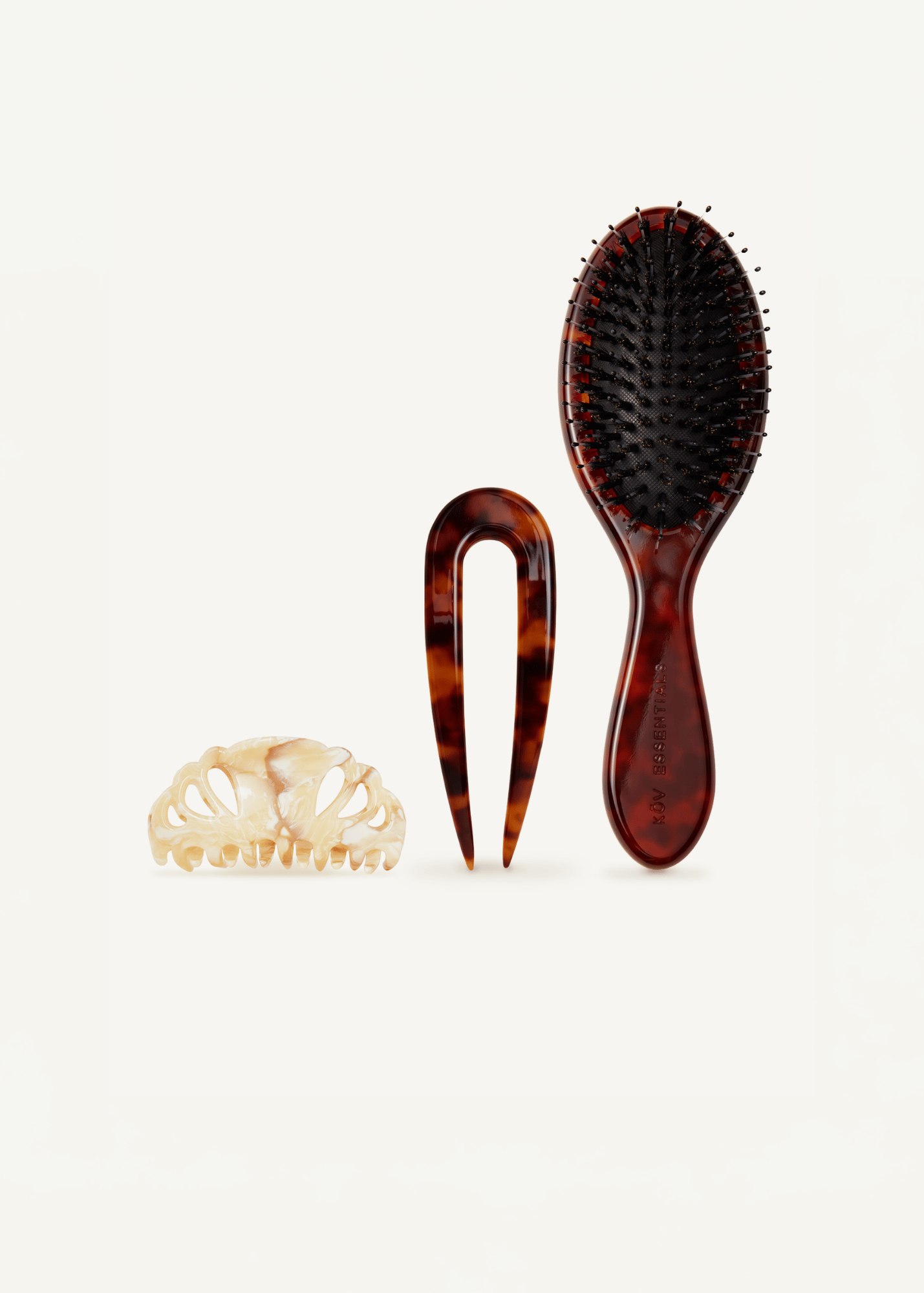 Icon Clip in Oak, French Pin in Tortoise, and Refine Hairbrush on a white background.