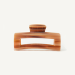 Caramel coloured hair clip on a white background