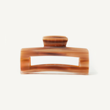 Caramel coloured hair clip on a white background