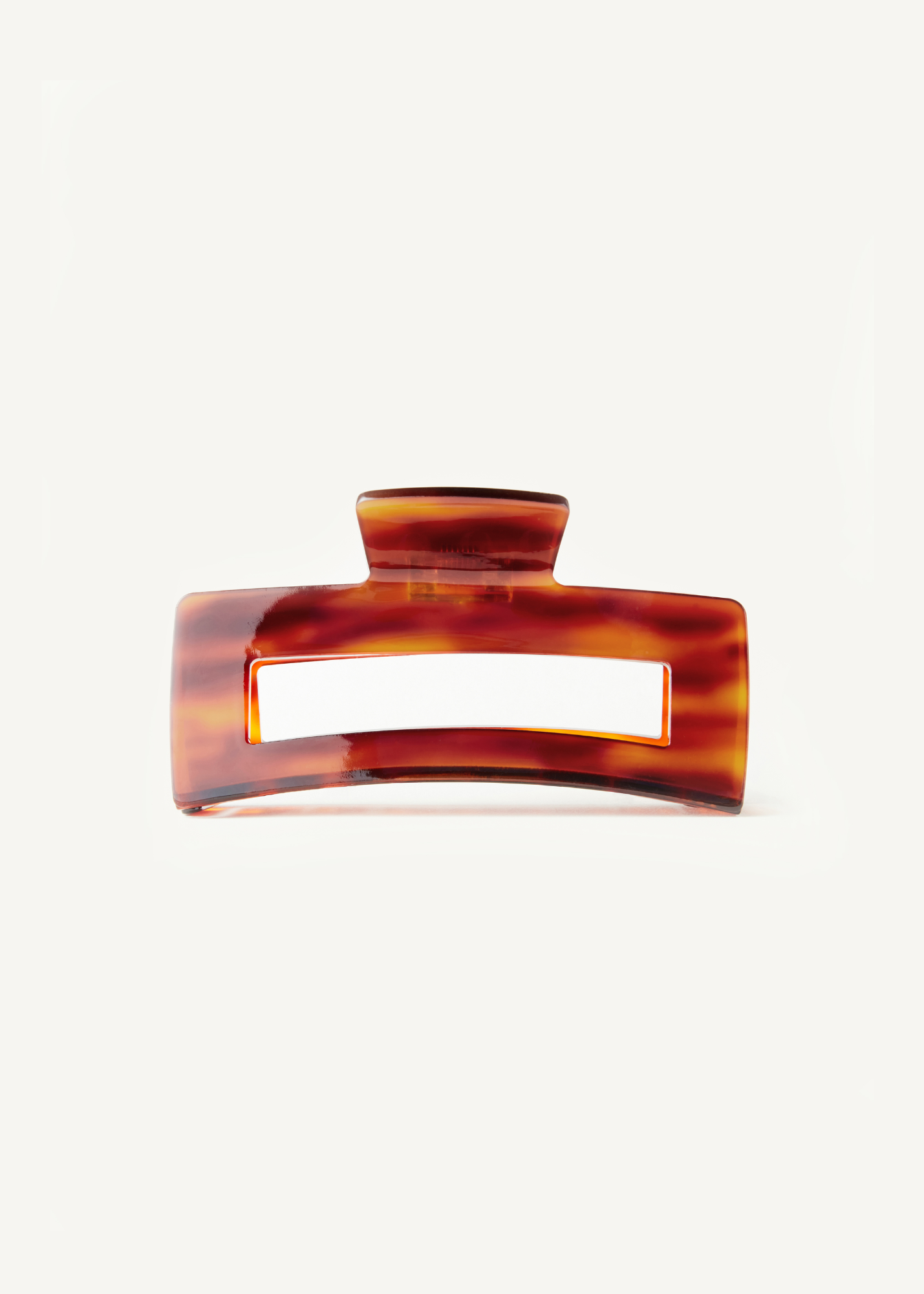 Red-toned neutral hair clip on a white background