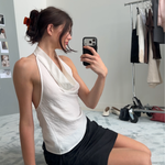 Woman taking a mirror selfie with a red-toned neutral hair clip in her hair
