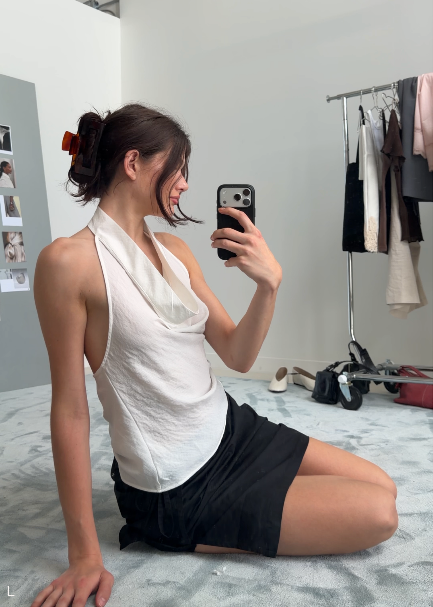 Woman taking a mirror selfie with a red-toned neutral hair clip in her hair