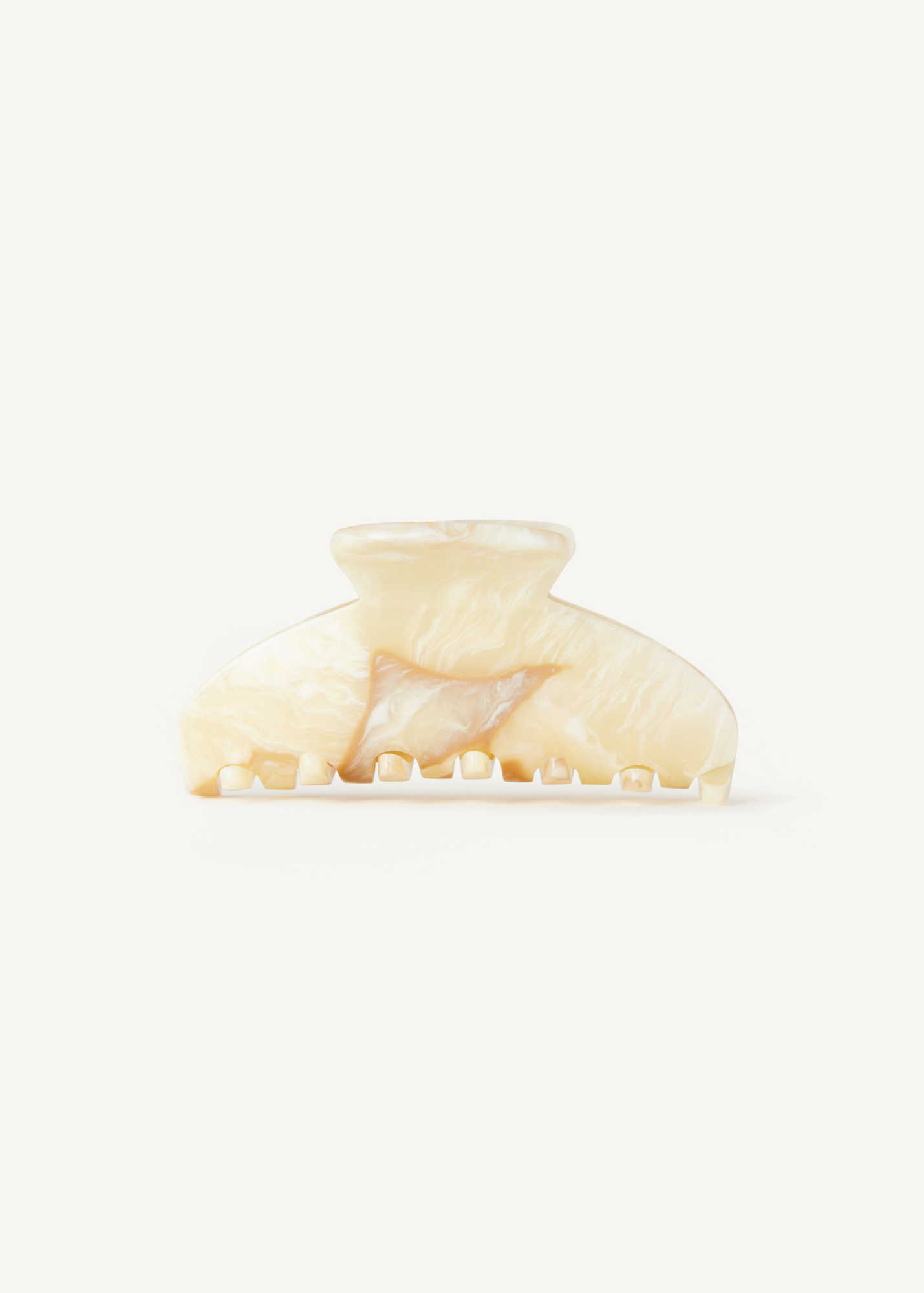 Cream claw clip on a white background.