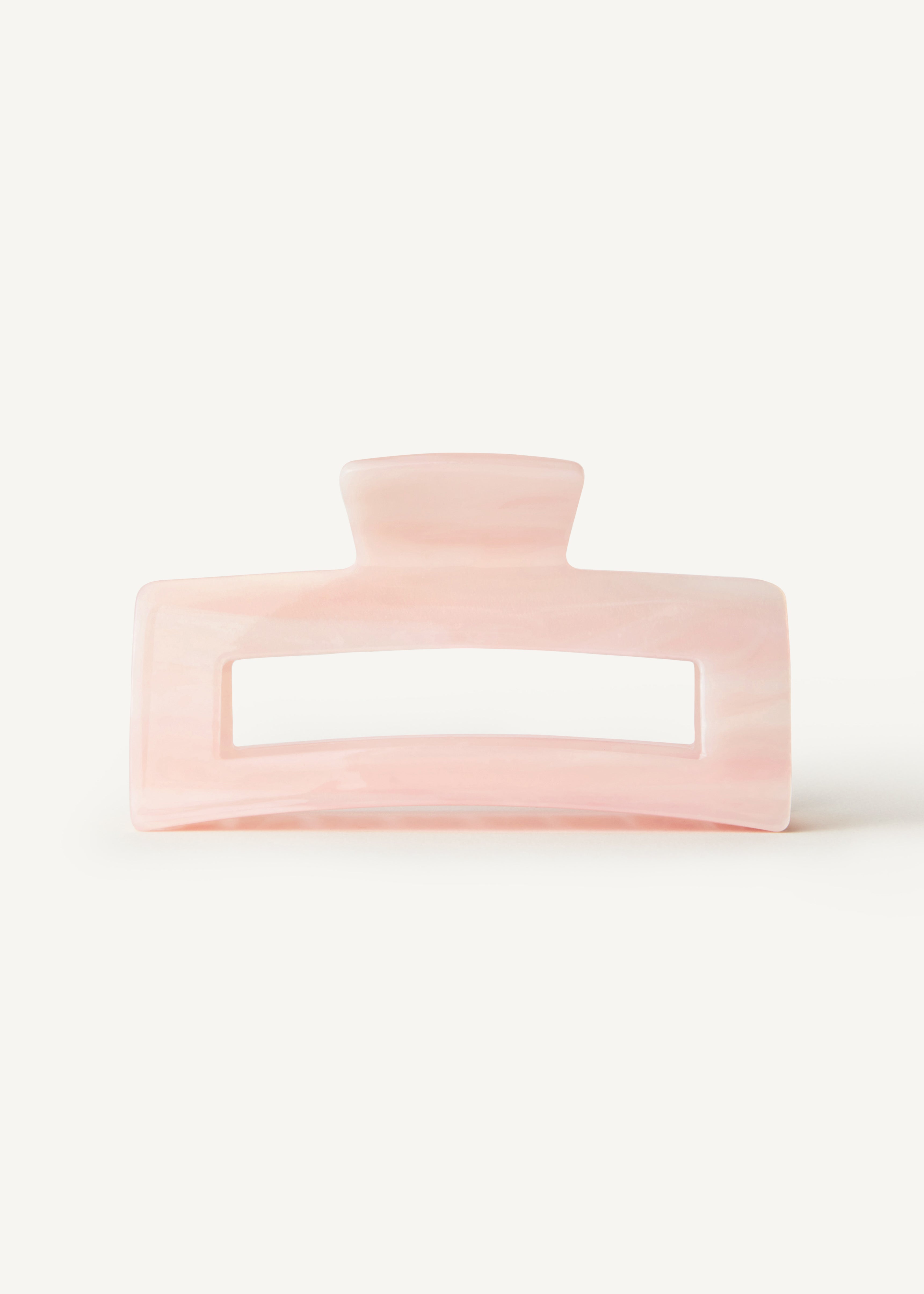 A pink hair clip against a white background