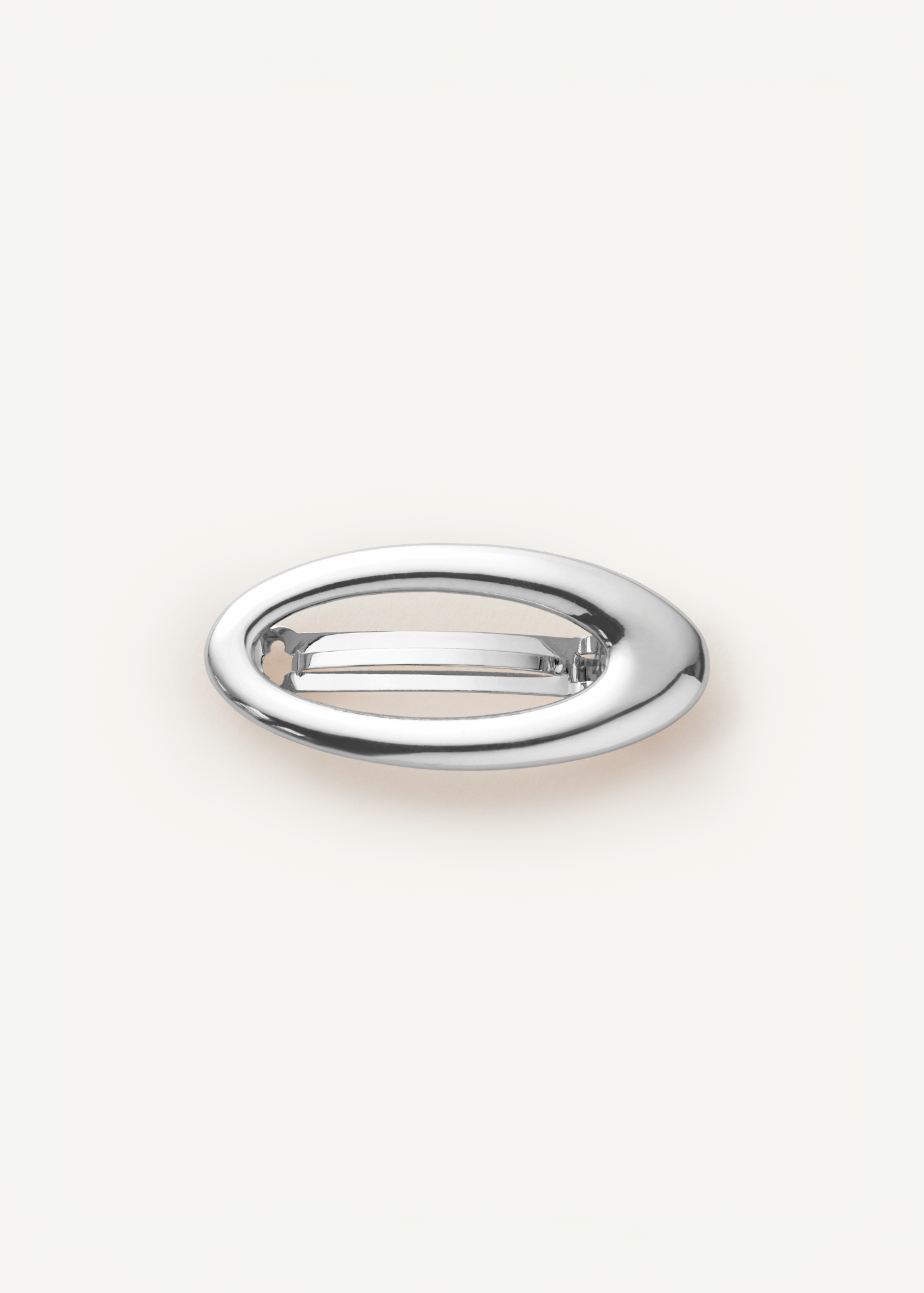 Silver metal barrette with a cutout in the middle on a white background