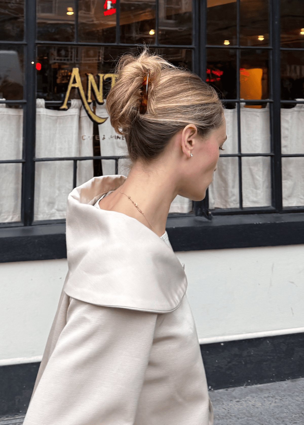 A woman with thick blonde hair secured in a twist style with a tortoiseshell hair comb