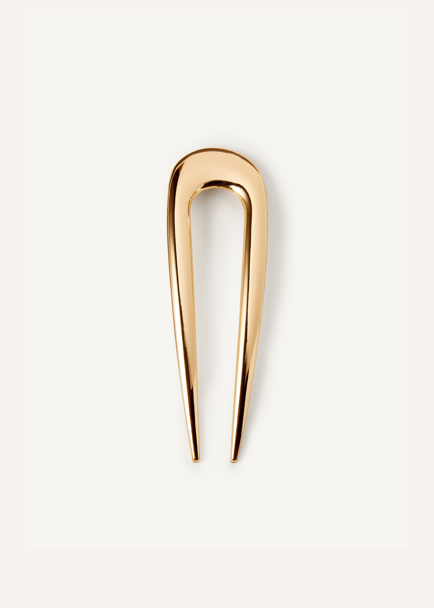 The French Pin in gold on a white background.