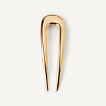 The French Pin in gold on a white background.