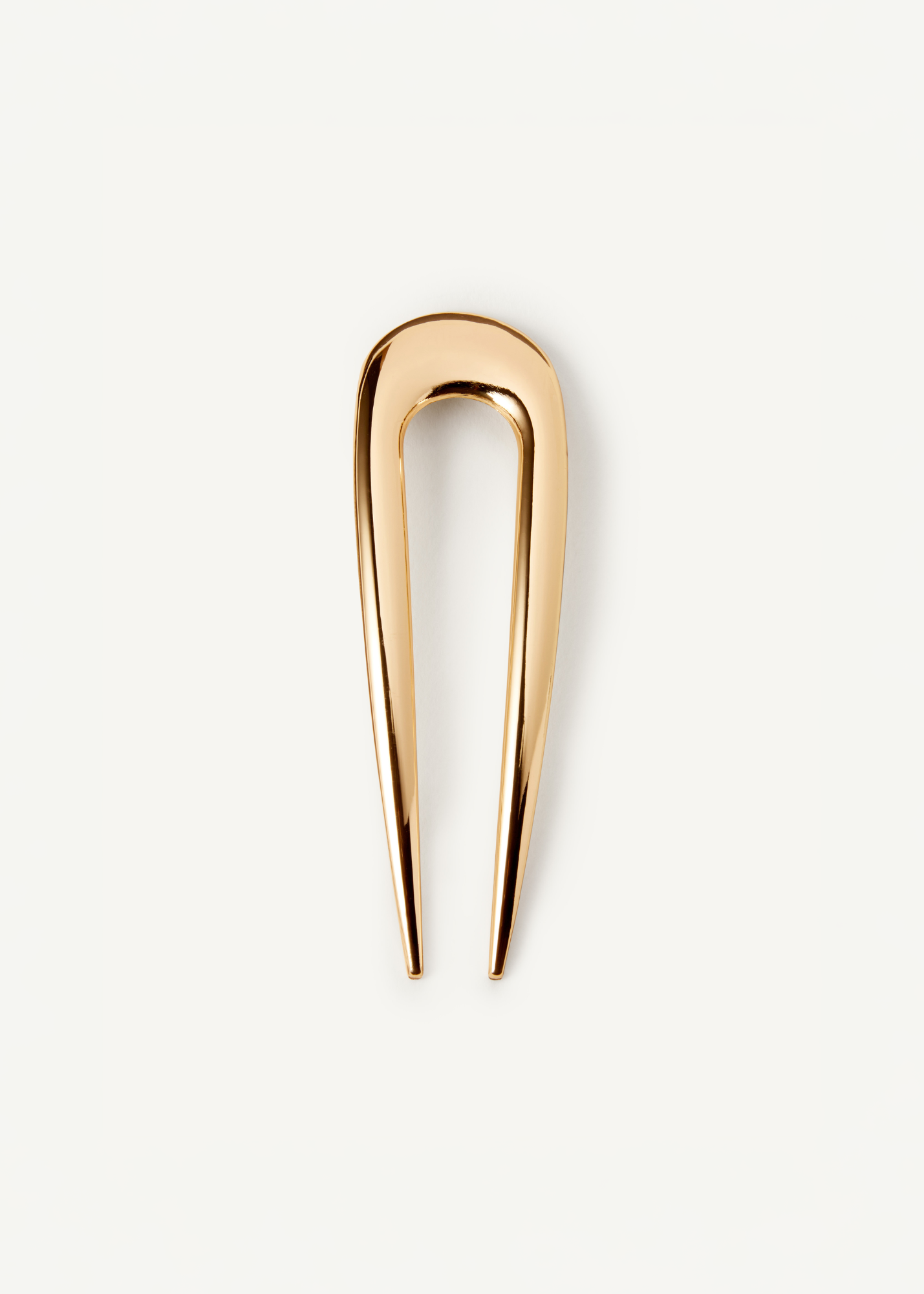 The French Pin in gold on a white background.