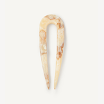 Cream hair pin on a white background.