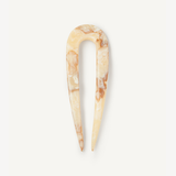 Cream hair pin on a white background.
