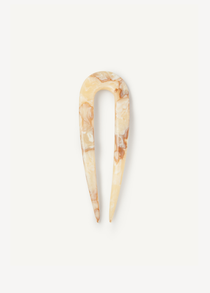 Cream hair pin on a white background.
