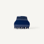 Small navy blue hair clip on a white background