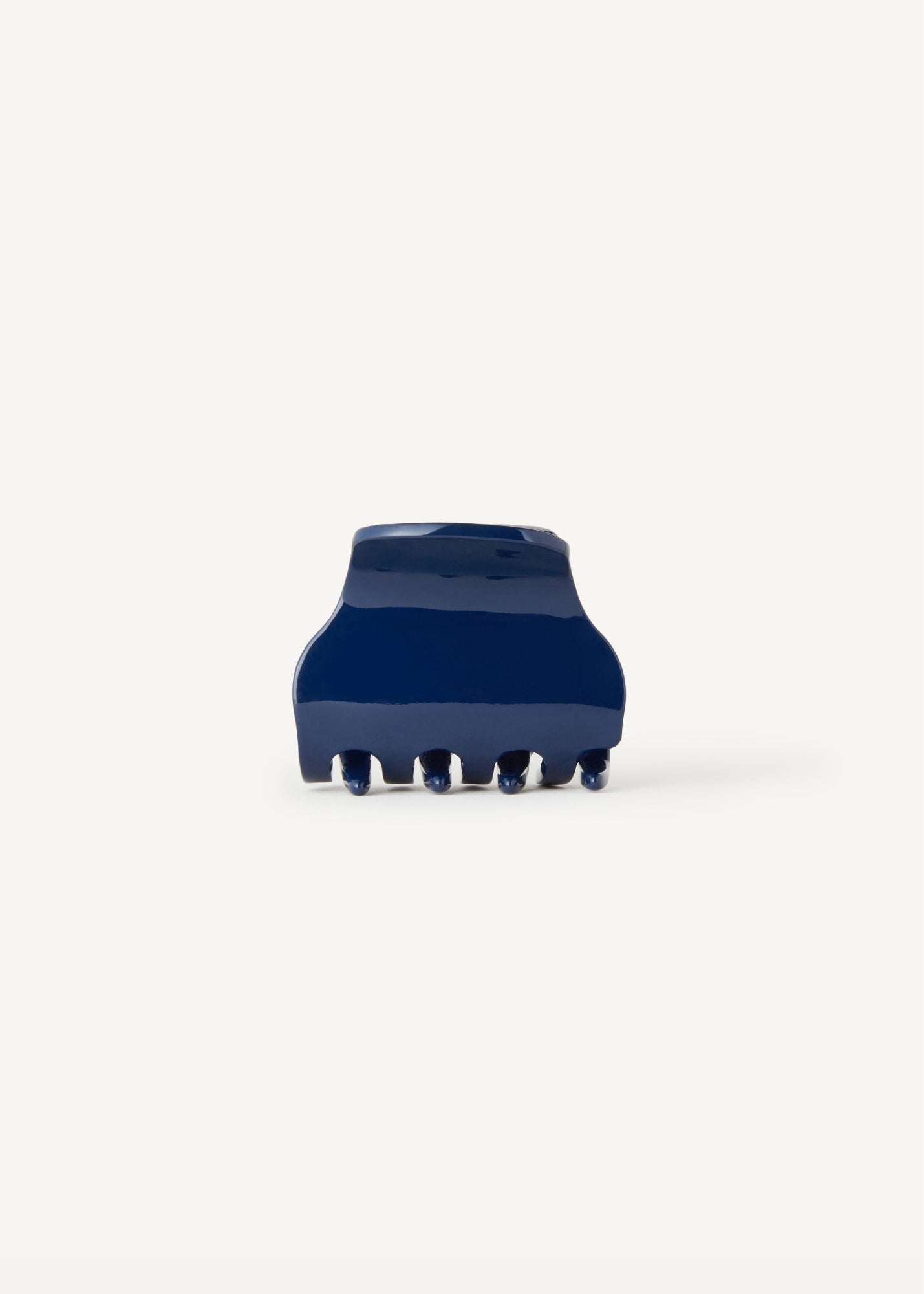 Small navy blue hair clip on a white background