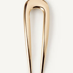 The French Pin in gold on a white background