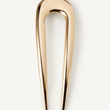 The French Pin in gold on a white background