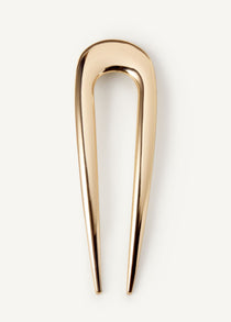 The French Pin in gold on a white background