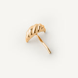 Gold croissant shaped hair accessory on a white background