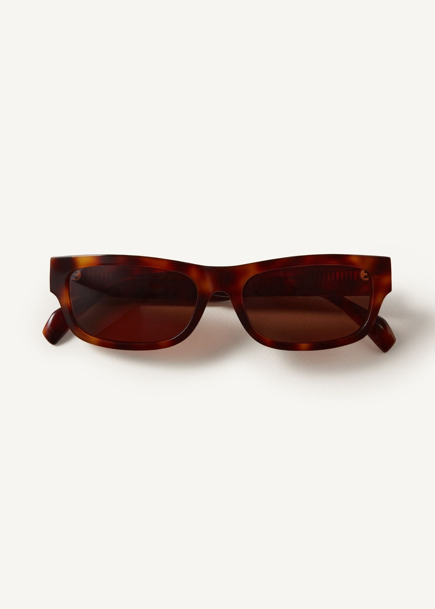 The Haven Sunglasses in Tortoise, rectangular shaped sunglasses, with brown lenses on a white background