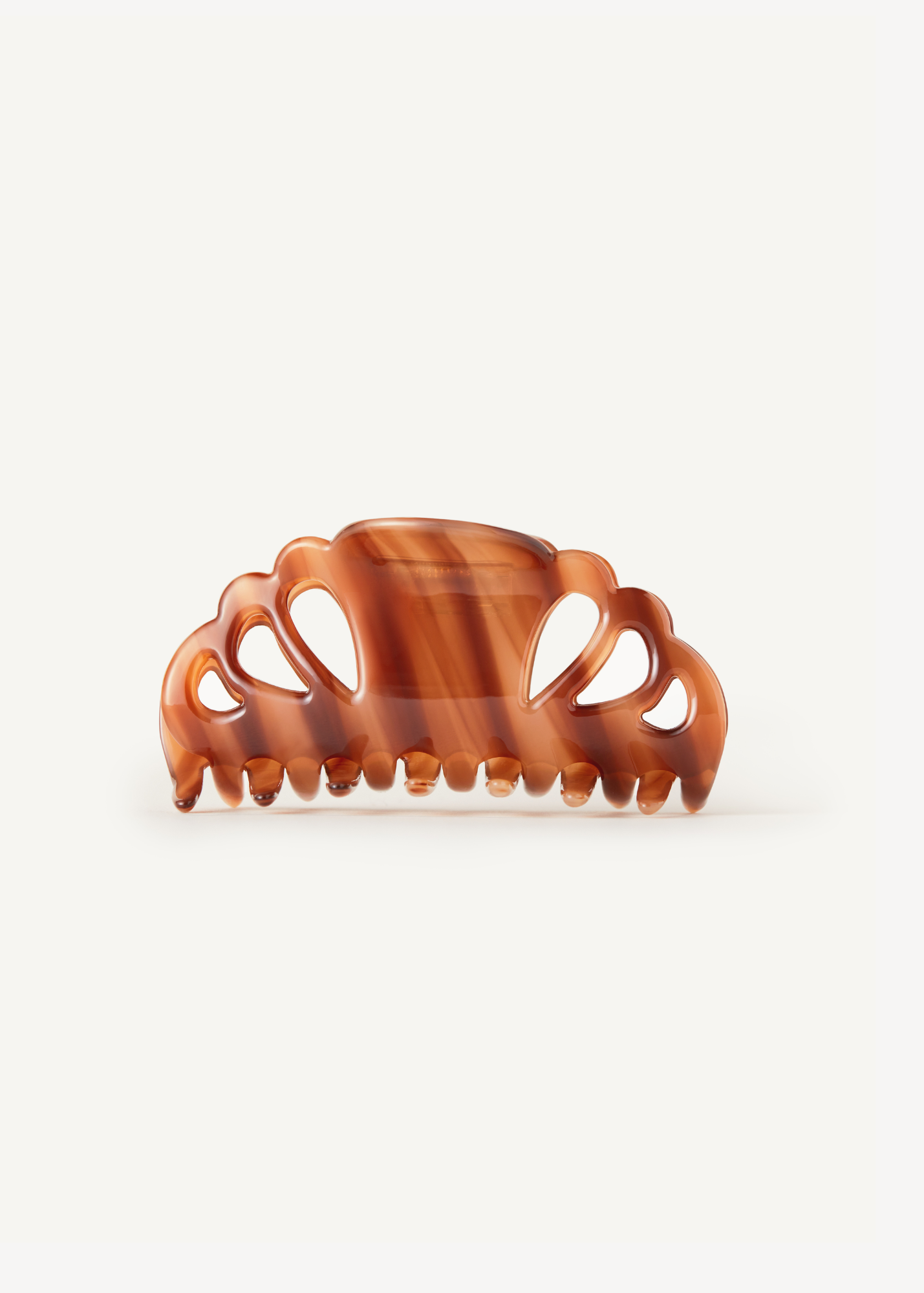 Brown tortoiseshell hair clip on a white background.
