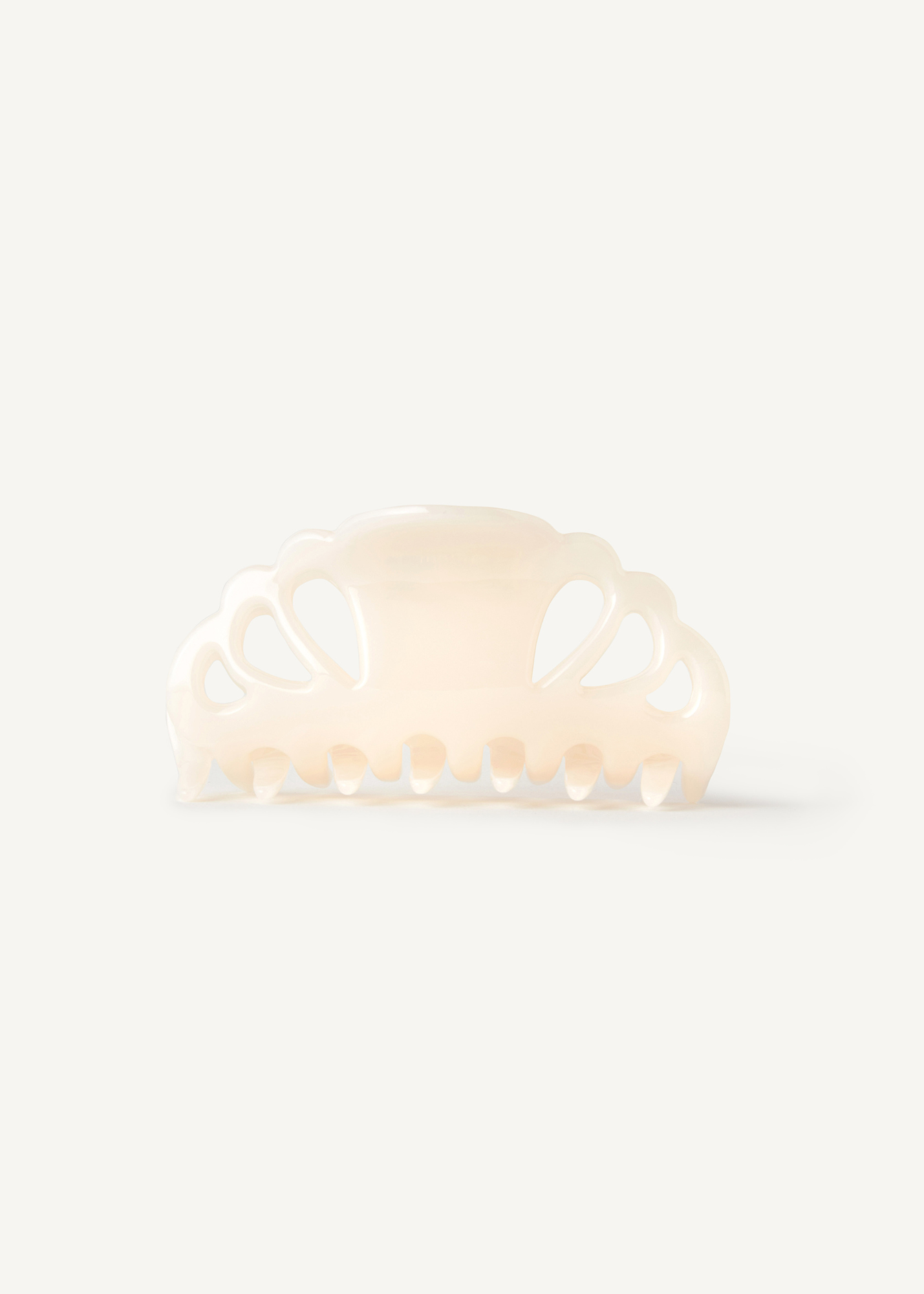 Cream hair clip on a white background