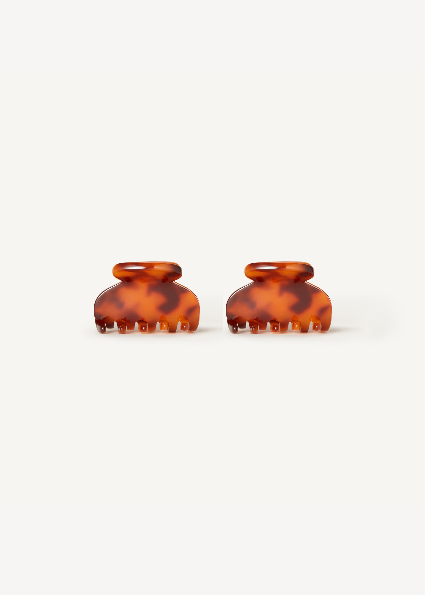 Two mini tortoiseshell claw clips on a white background.