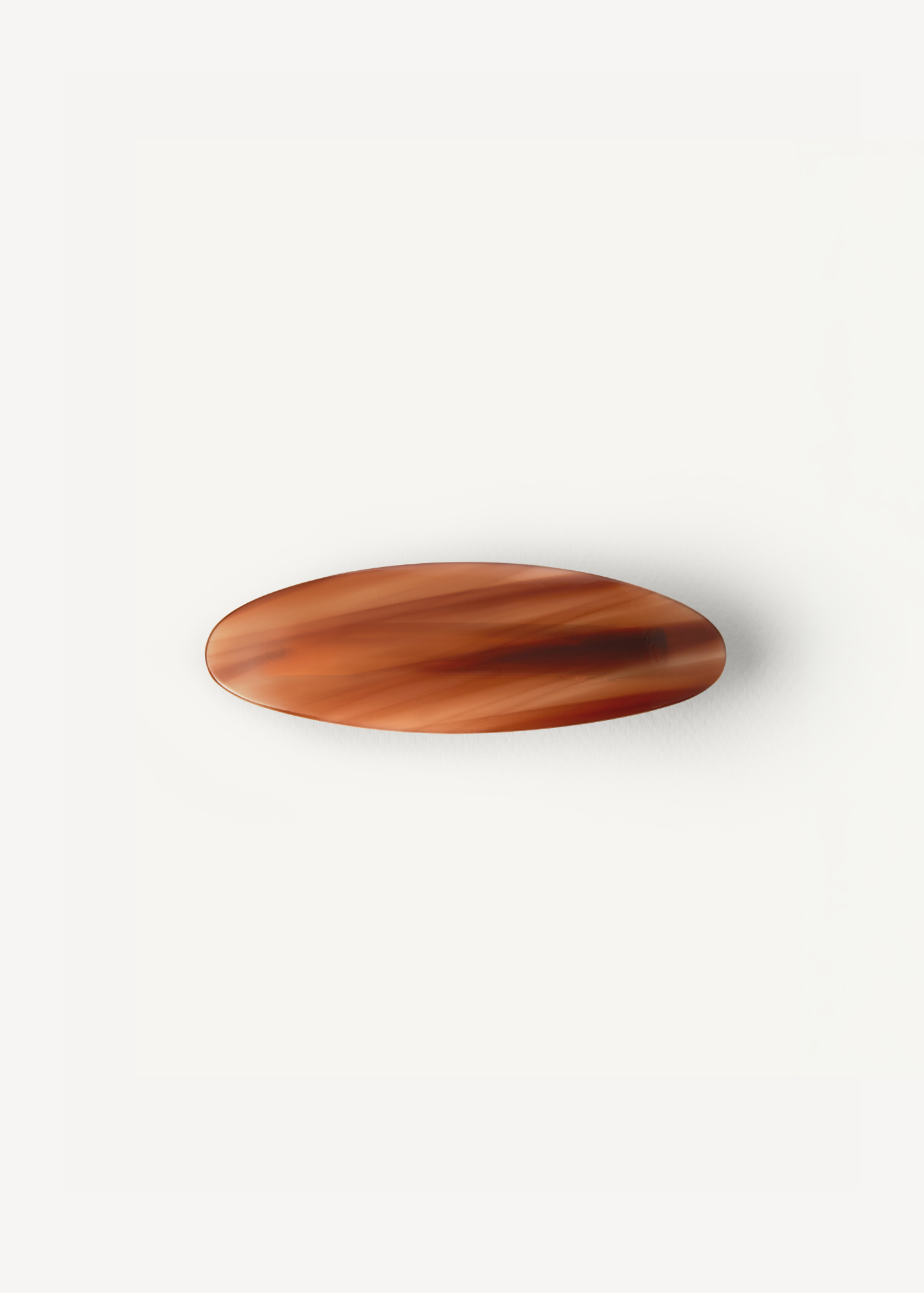 The Oval Barrette in Honey on a white background