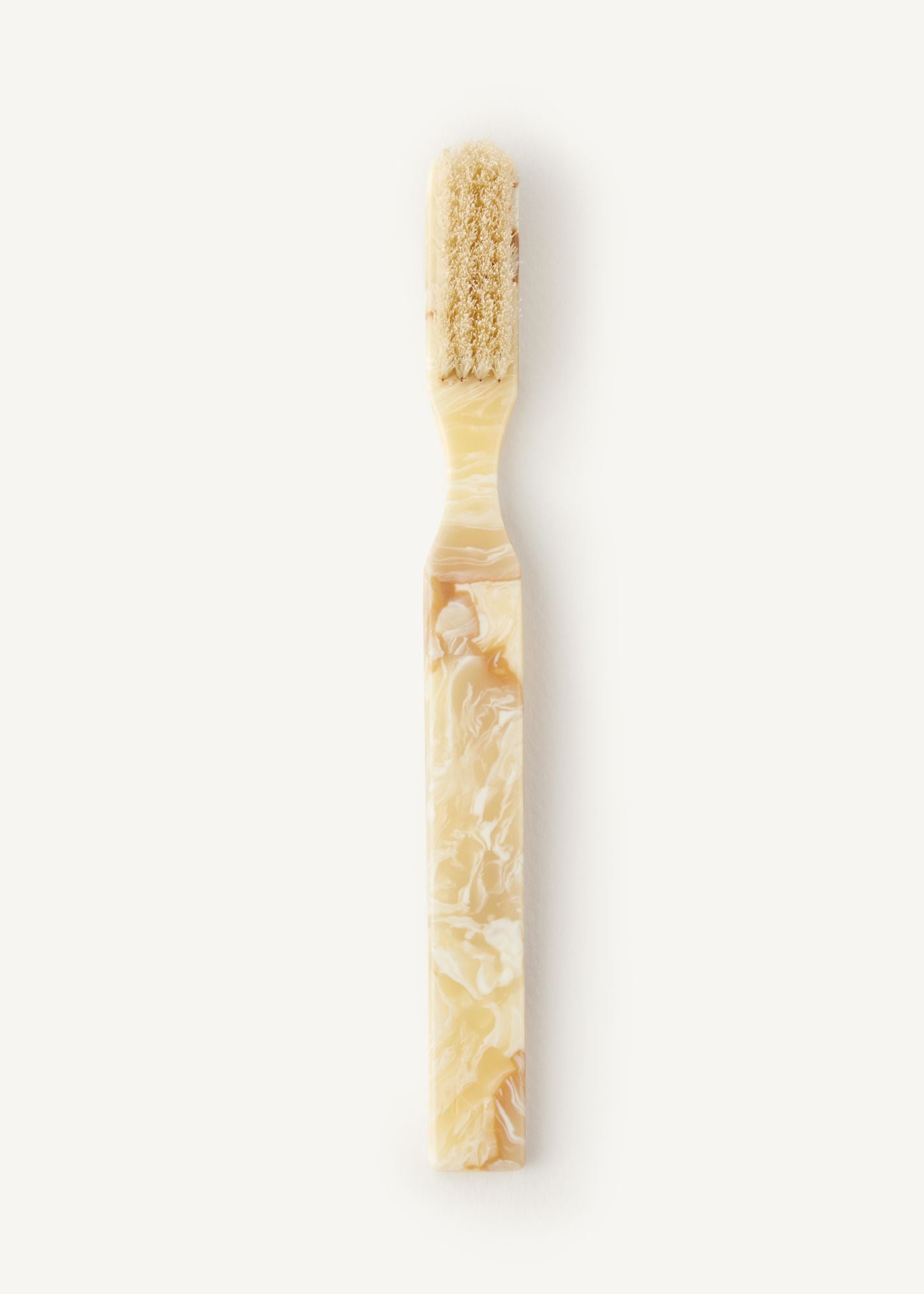 The Detail Brush in Oak, a boar bristle brush in a light cream colour on a white background