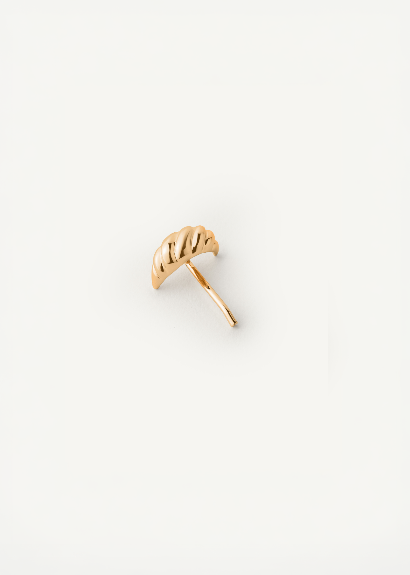 Croissant shaped hair cuff in gold on a white background