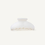 Pearl coloured hair claw clip on a white background