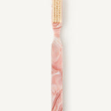 Pink marbled style hairbrush with beige coloured bristles on a white background