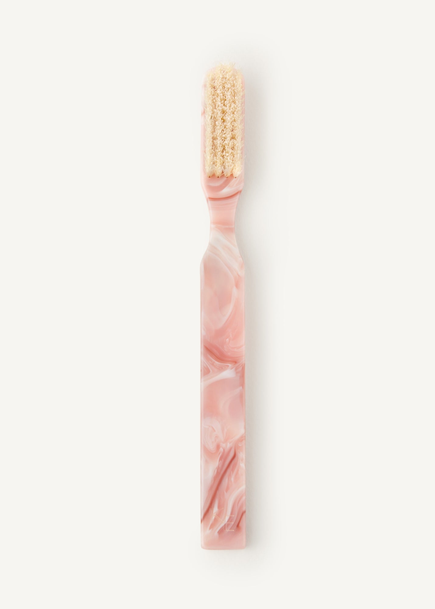 Pink marbled style hairbrush with beige coloured bristles on a white background