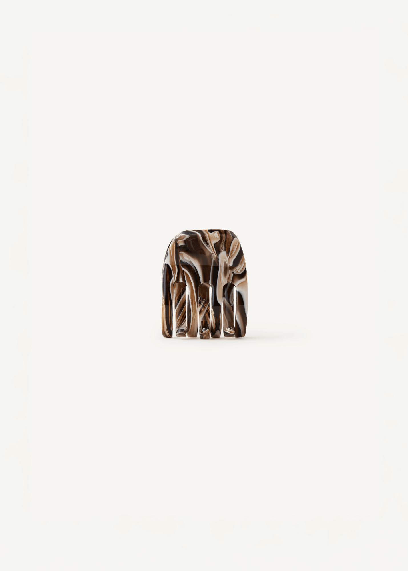 A small claw clip with an abstract marbled pattern in brown, beige, and black, centered on a plain off-white background.