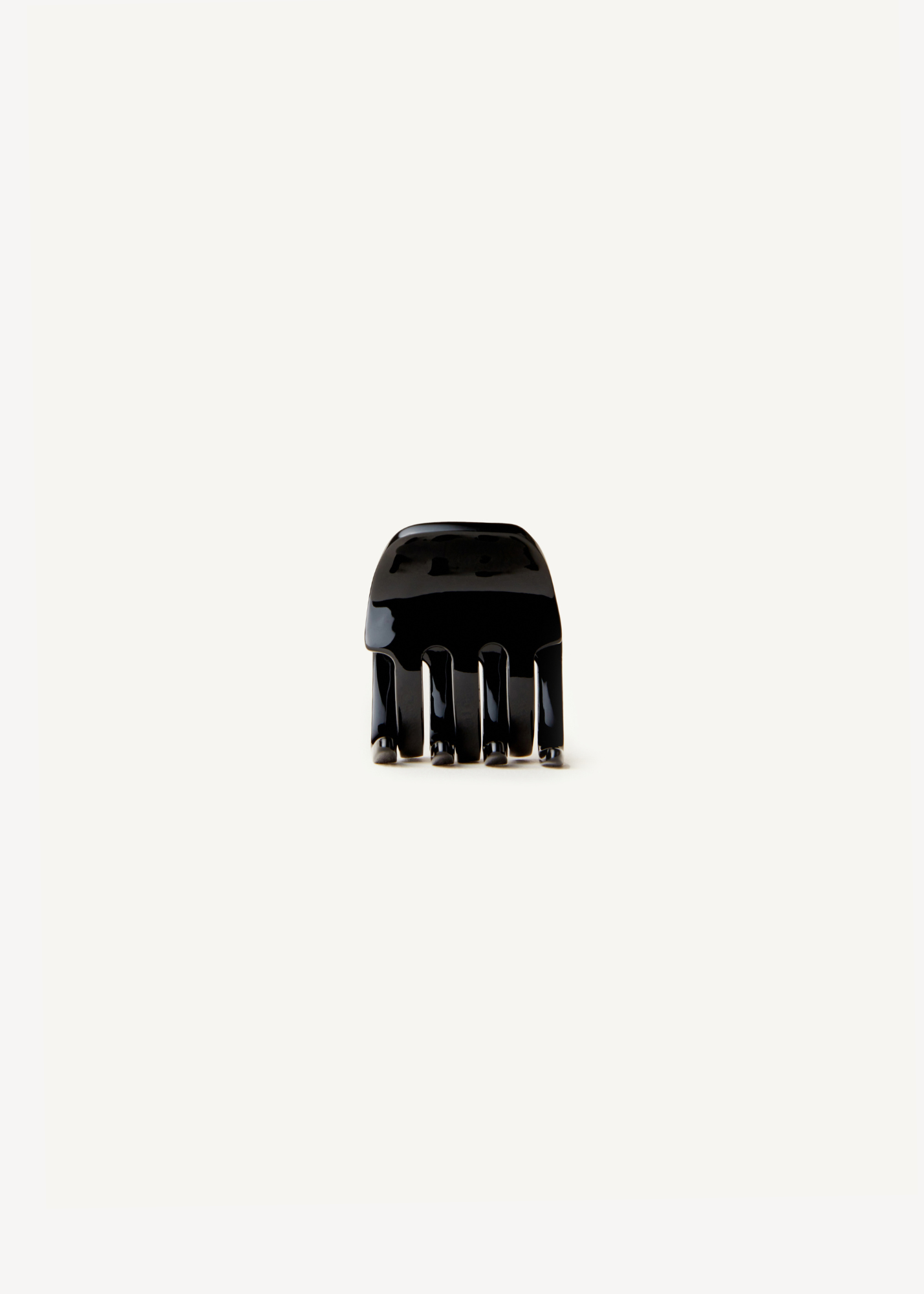 Small black claw clip on a white background.