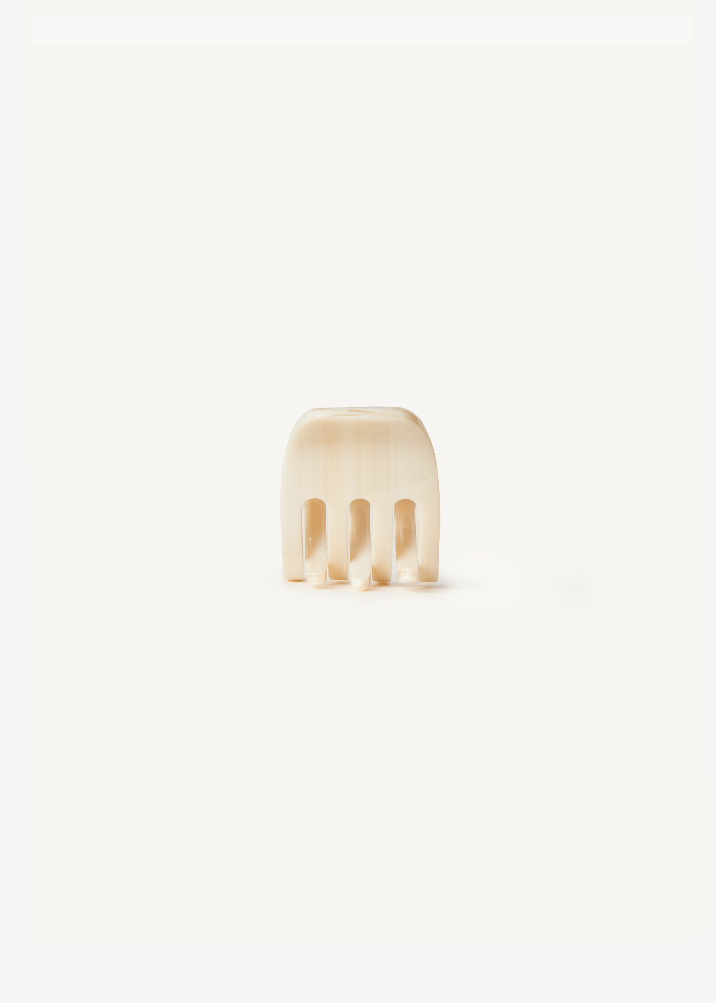 Small beige claw clip on a white background.