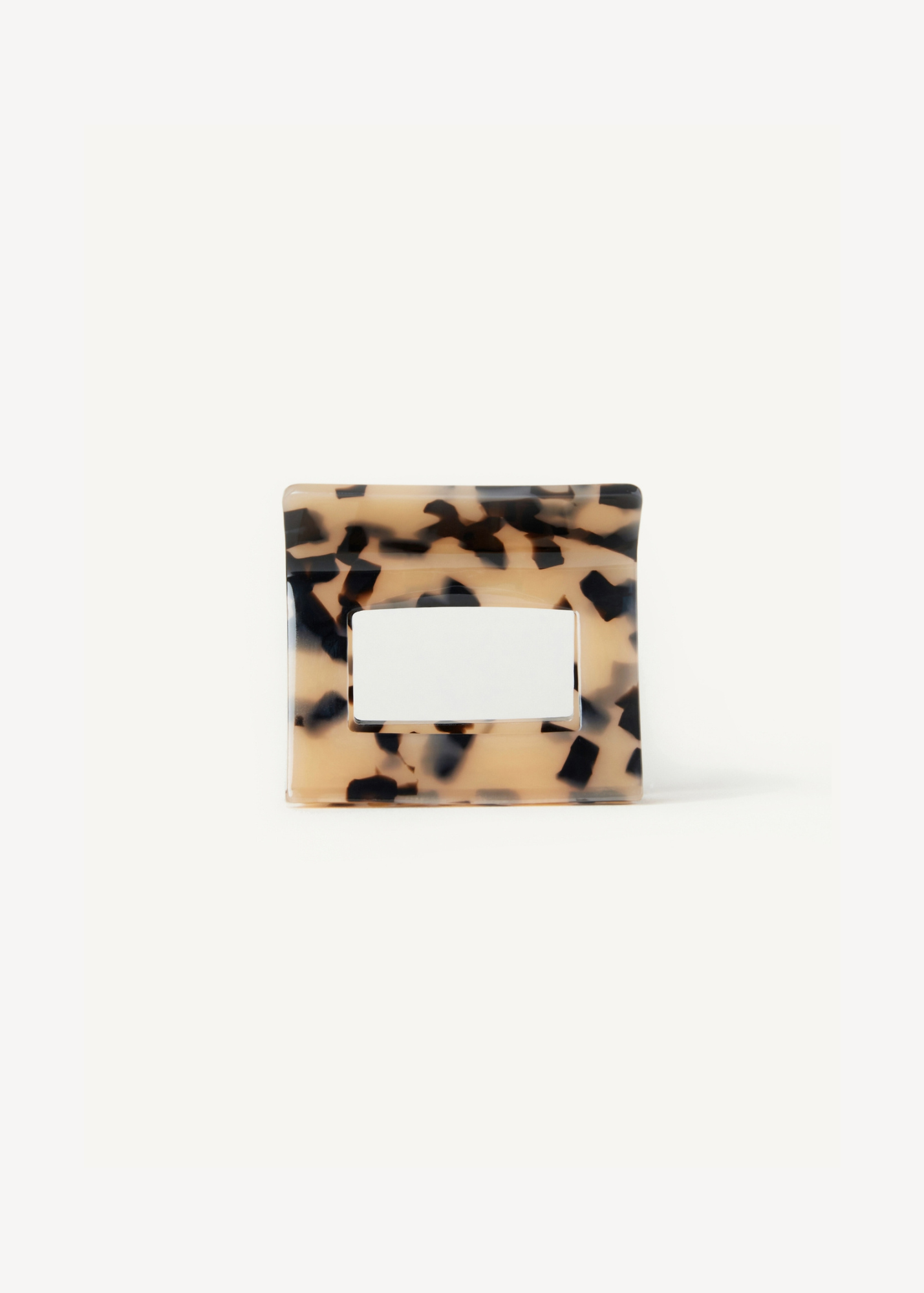 Tortoiseshell hair clip on a white background.