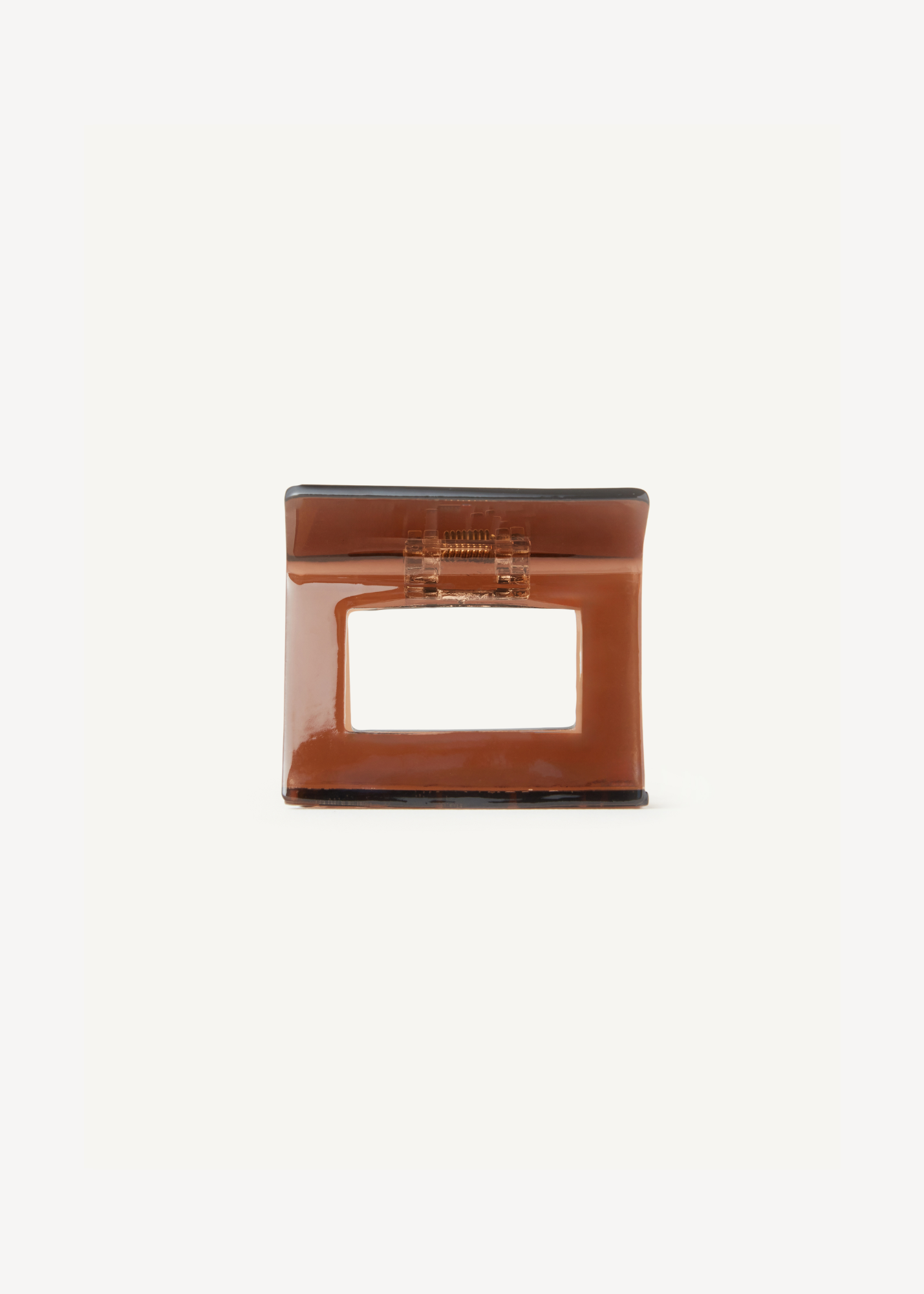 Brown hair clip on a plain white background.