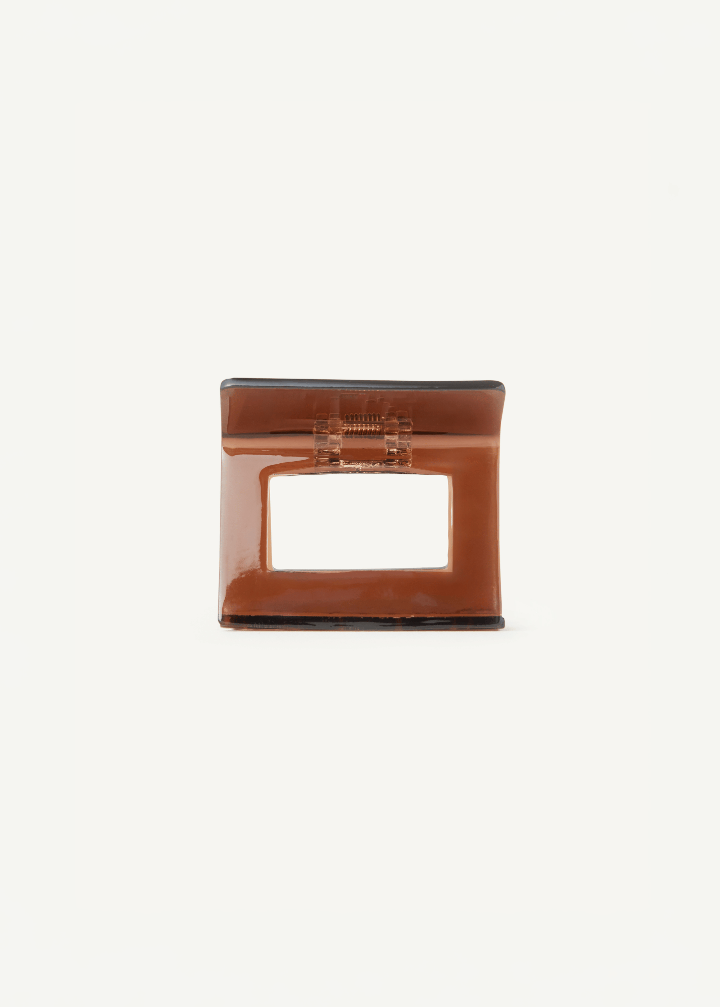 Brown hair clip on a plain white background.