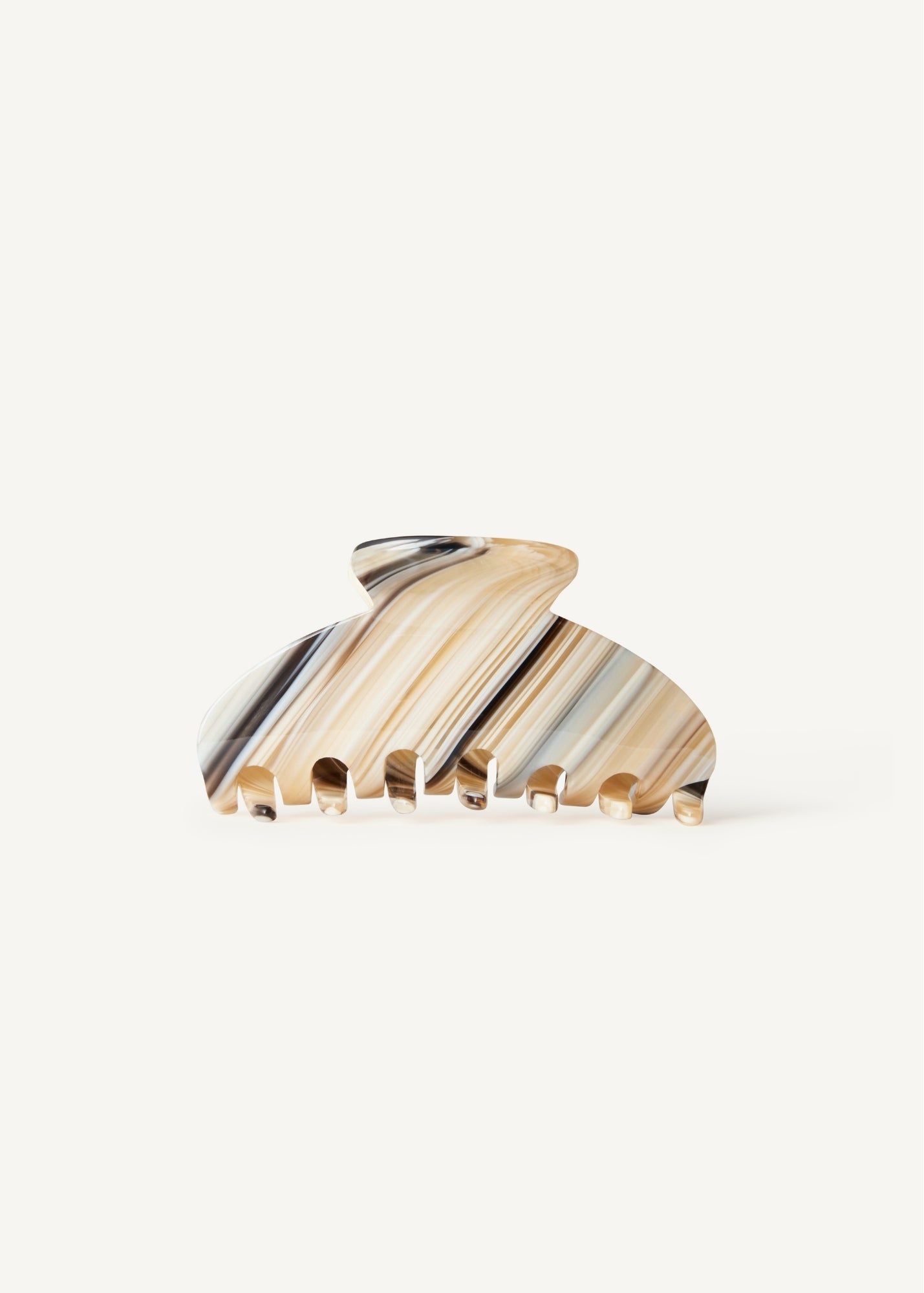 A striped pattern claw clip with beige, dark and light blue stripes on a white background
