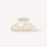 Pearl-coloured shell-shaped claw clip clip on a white background