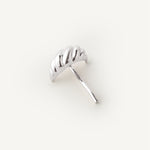 Silver croissant shaped hair accessory on a white background