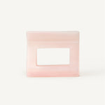 Rectangular pink hair clip on a white background