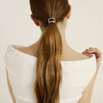 Woman with chestnut coloured hair in a hair cuff ponytail