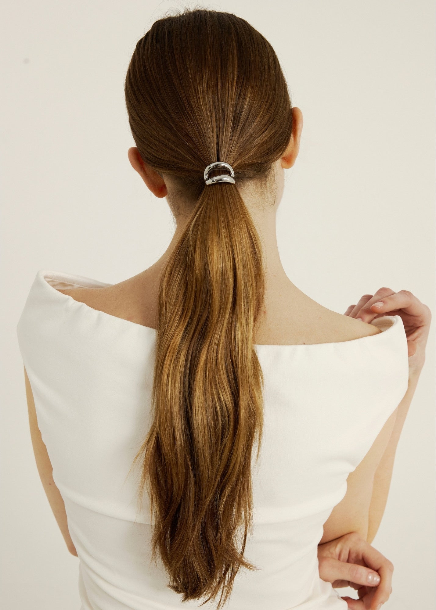 Woman with chestnut coloured hair in a hair cuff ponytail