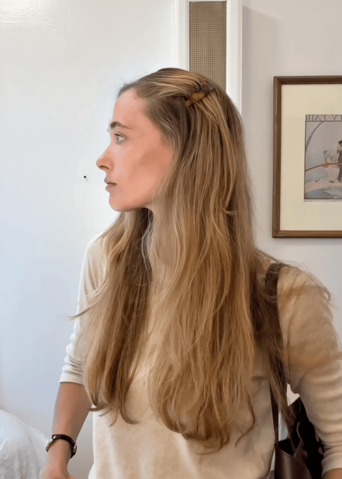 A video of a young woman demonstrating two ways to wear side combs. Once is a half up style while the other sweeps the hair away from one side of her face. 