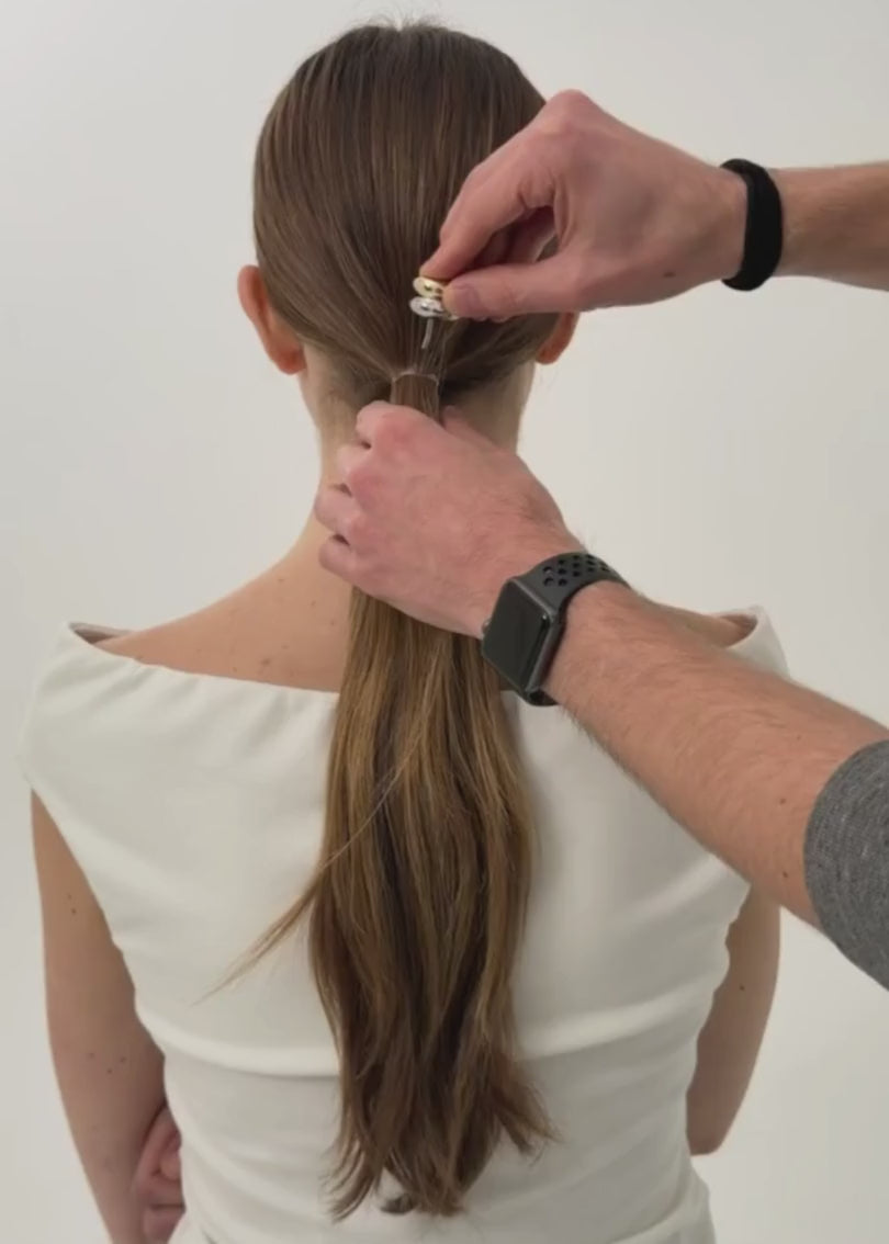 Woman with long brown hair, styled in a ponytail featuring the Mixed Metal Hair Cuff against a white background